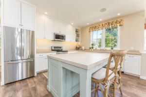 a kitchen with white cabinets and a large island at Harmony Meadows Tennis Resort in Manson