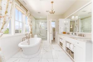 a white bathroom with a tub and a sink at Harmony Meadows Tennis Resort in Manson