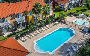 uma vista superior de uma piscina em frente às casas em Cozy Three Bedrooms Townhome at Lake Berkley Resort (1123) em Kissimmee