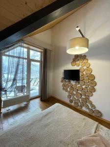a bedroom with a bunch of logs on the wall at Girske Povitria 2 in Yaremche