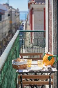 - une table sur un balcon avec un bol et des verres dans l'établissement Downtown Apartments, à Lisbonne