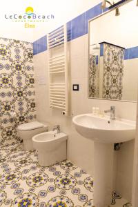 uma casa de banho com um lavatório e um WC em Le Coco Beach Apartaments em Ascea