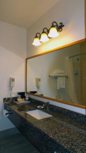 
a bathroom with two sinks and a mirror at Best Western Gold Canyon Inn & Suites in Gold Canyon
