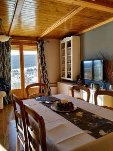 a dining room with a table and chairs and a television at Apartamento María en Valdelinares VUTE-21-041 in Valdelinares