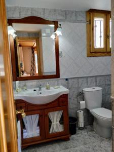 a bathroom with a sink and a toilet and a mirror at Apartamento María en Valdelinares VUTE-21-041 in Valdelinares