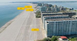 a view of a beach with yellow squares on it at Sea On in Mamaia