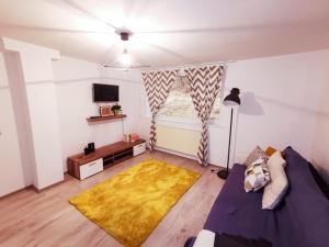 a living room with a bed and a window at 105500 Apartment in Buşteni