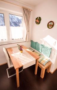a dining room with a table and a bench at Panorama Ferienwohnung Reich in Oetz