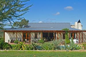 ein Haus mit einem Metalldach in der Unterkunft River Bend Lodge in Addo