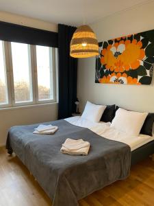 a bedroom with a large bed with two towels on it at Stava Mosters in Mariehamn