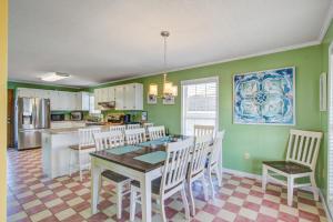 a kitchen with a dining room table and chairs at Dibbs on Holden in Holden Beach