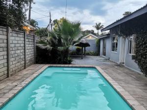 a swimming pool in the backyard of a house at Bono Luxury Guesthouse in Rustenburg