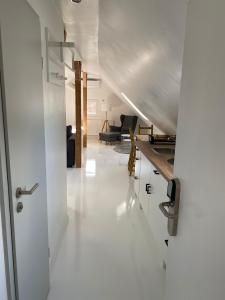 a white hallway with a living room in a house at StayStay Guesthouse I 24 Hours Check-In in Nuremberg