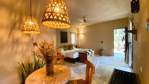 a living room with a table and two lights at Hotel Boutique Refugio 41 in Valladolid