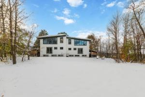 a white house in the snow with trees at 12 Beds Sleep 16 Chalet with HotTub, 2min to Blue in Blue Mountains