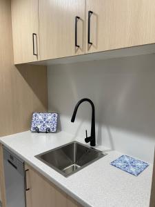 a kitchen with a sink and a counter top at Veld View Bed and Breakfast in Tuakau