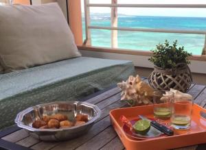 a table with a tray of food on top of a couch at ilococo in Sainte-Anne