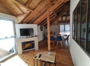 a living room with a fireplace and a table at Obalie-Le Vignemale in Cauterets