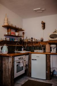 a kitchen with a white stove and a sink at Chatka Zapiecek in Krościenko