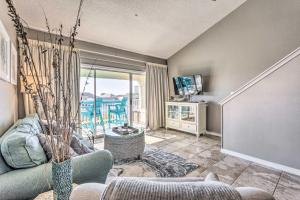 a living room with a couch and a tv at Well-Appointed Family Condo on Miramar Beach! in Destin