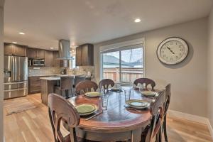 a dining room table with chairs and a clock on the wall at Family-Friendly Redmond Getaway Walk to Dtwn in Redmond