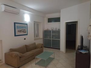 salon z kanapą i telewizorem w obiekcie Appartamento sul Corso w mieście Porto Recanati