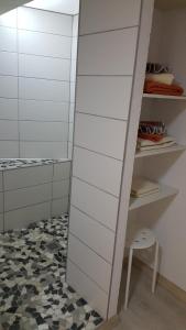 a walk in closet with white cabinets and a stool at Ferienwohnung Nicole in Schneeberg