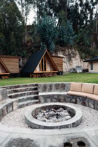 a fire pit in a yard with a tent at Hawkay Glamping in San Miguel de Salcedo