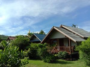 a house with a porch and a roof at Cha Bungalow in Ko Yao Noi
