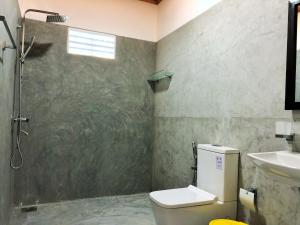 a bathroom with a shower and a toilet and a sink at Sunflower Beach Resort in Beruwala