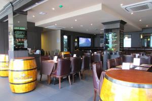a restaurant with wooden tables and chairs and barrels at The Southbridge Hotel in Singapore