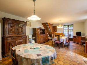 a living room with a table and a dining room at Gîte Montignac, 5 pièces, 8 personnes - FR-1-616-218 in Montignac