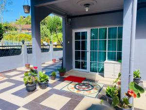 a porch with potted plants and a patio at 100 Oastel coLiving in Tanah Rata