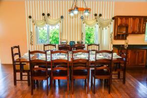 a dining room with a wooden table and chairs at RunAway to Tranquility, overlooking the Bay in Runaway Bay