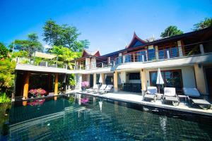 a house with a swimming pool in front of it at Luxury 5 bedrooms Villa with Seaview Infinity Pool overlooking Surin Beach in Surin Beach
