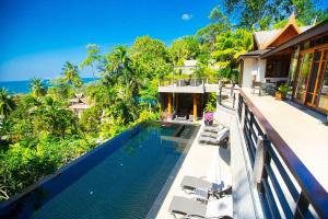 an external view of a villa with a swimming pool at Luxury 4 bedrooms Villa with Seaview Infinity Pool overlooking Surin Beach in Surin Beach