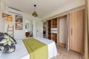 a small bedroom with a bed and a closet at 373 Wolmar Cosy and Modern Apartment- 200 metres from the Beach and Supermarkets and just next to Domaine de wolmar with views of deers and green natural park in Flic-en-Flac +70 photos