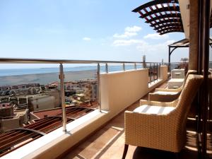a balcony with chairs and a view of the ocean at Millennium Apart Complex in Sveti Vlas