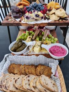 a table with a buffet of cheese and bread at Canyonleigh Retreat in Canyon Leigh