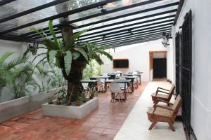 a patio with a table and chairs and a plant at Lost & Found - Colombo in Colombo
