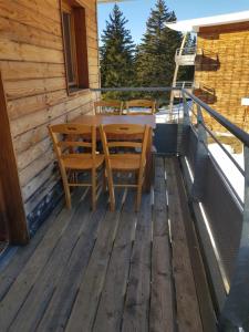 尚魯斯的住宿－L'Après-ski Chamrousse 1700，木甲板配有桌椅