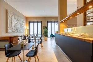 a restaurant with tables and chairs and a counter at Hotel Nuova Grosseto in Grosseto