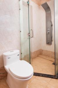 a bathroom with a toilet and a shower at Hapyson in Long Khanh