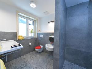 a bathroom with a toilet and a sink at Ferienhaus Birkenweg Oberstdorf in Oberstdorf +27 photos