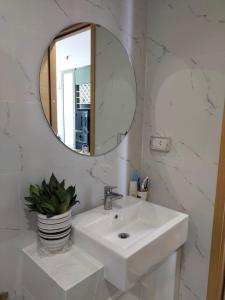 une salle de bain avec un lavabo et un miroir dans l'établissement GRAND HYCHARMS serviced STUDIO, à Quy Nhơn