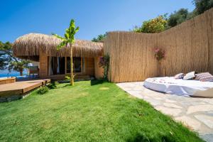 a bedroom with a bed in a grass yard at Heaven Resort Faralya in Faralya