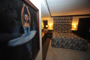 a woman standing on a bed in a room at Ontur Butik Hotel in Ankara