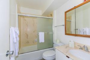 a bathroom with a shower and a toilet and a sink at Ilikai Marina Studio City View Condos with Fully Equipped Kitchens & Free Wifi in Honolulu