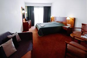 a hotel room with a bed and a couch at Athens Mirabello in Athens +34 photos