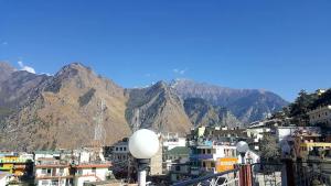 a view of a city with mountains in the background at HOTEL MOUNTAIN VIEW in Joshīmath